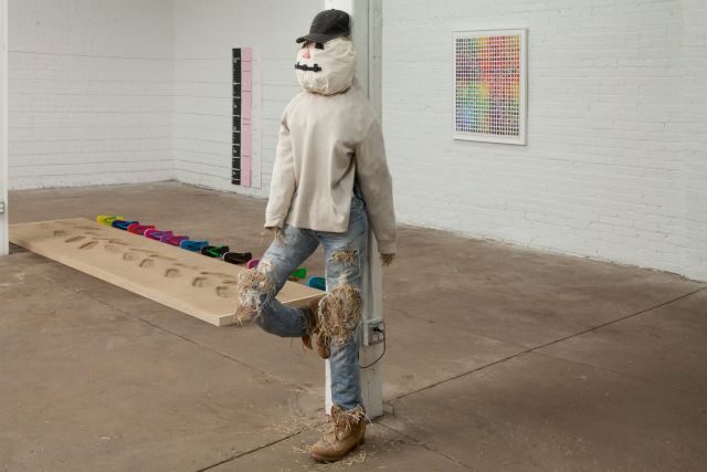 Ultraviolet Production House, Installation view from Showroom, Bahamas Biennale, Detroit, works pictured: Lean In To Walking: Customizable Resume Sand Impression Sandals, 2017; Family Growth Charts: Map your child’s yearly height in comparison to the projected rise of sea levels over the next 100 years, 2017; This Paintstaking 2,000 Piece Wifi Password Jigsaw Puzzle Will Likely Keep Your AirBNB Guests Busy Long Enough to Avoid Stealing Your Possessions, 2017; Automated Promotion or Dire Warning? This Scarecrow Playing A Live Feed of A Conversation Taking Place Inside at Full Volume Outdoors Will Get The Business You Place it In Front of Whatever Customers It Deserves (Brad), 2017