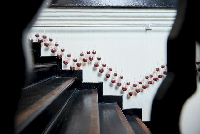 Kumari Nahappan, Drop Drop Droppings, 2022/2023, Saga seeds, plastic baubles, Dimensions variable. Photo: Courtesy of The Private Museum, Singapore